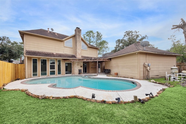 view of swimming pool featuring an in ground hot tub, a patio area, and a lawn