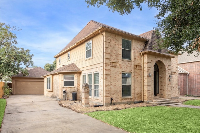 view of front of house with a garage and a front lawn