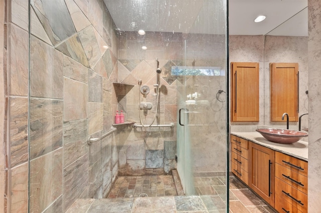 bathroom featuring vanity, an enclosed shower, and tile walls