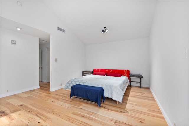 bedroom with hardwood / wood-style flooring and vaulted ceiling