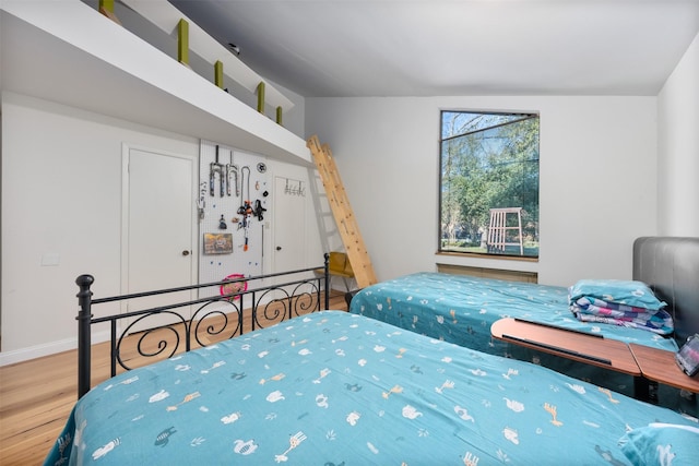 bedroom with hardwood / wood-style flooring and vaulted ceiling