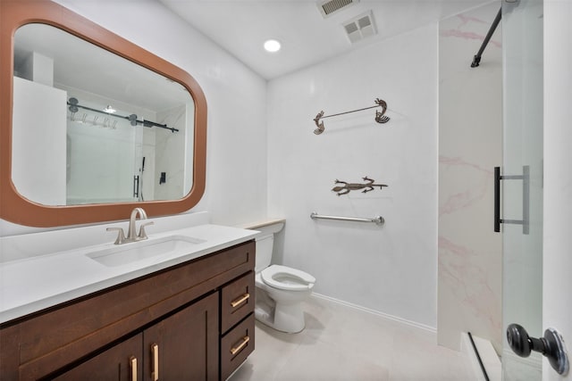 bathroom featuring tile patterned flooring, vanity, toilet, and walk in shower