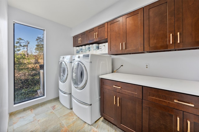 laundry area featuring cabinets and washing machine and clothes dryer