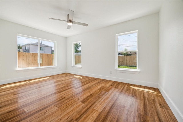 empty room with wood-type flooring and ceiling fan