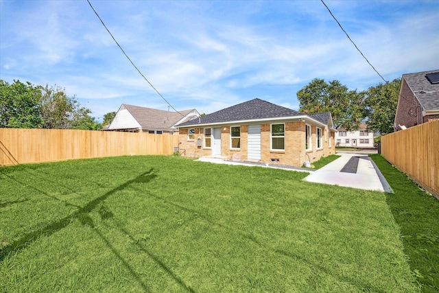 back of house featuring a yard and a patio