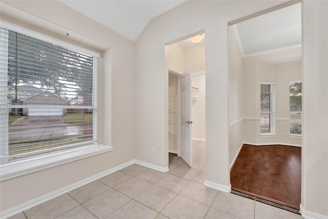 interior space with lofted ceiling, a wealth of natural light, and tile patterned floors