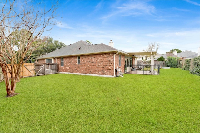 back of property featuring a yard and a patio area