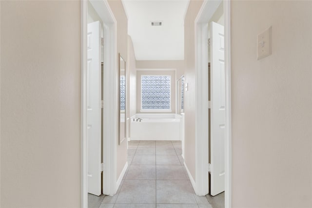 hall with light tile patterned flooring