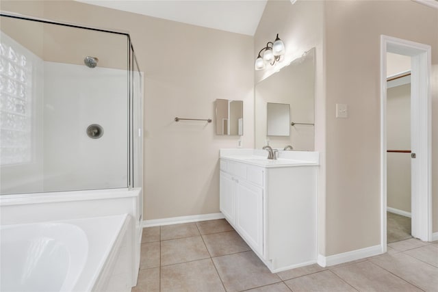 bathroom featuring vanity, a bath, and tile patterned floors