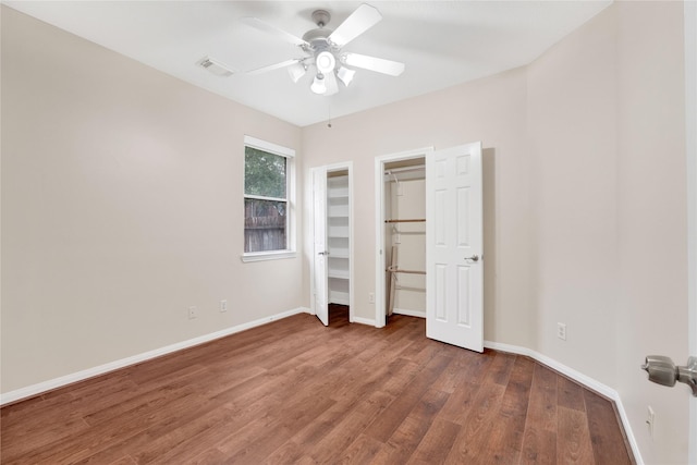 unfurnished bedroom with dark hardwood / wood-style floors and ceiling fan