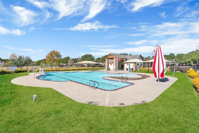 view of swimming pool featuring a yard and a patio area