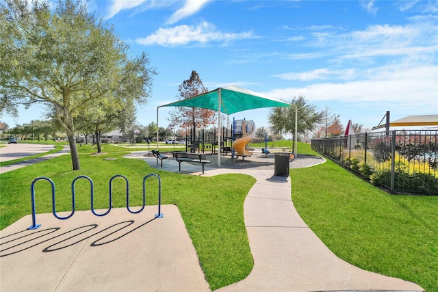 view of home's community featuring a lawn and a playground