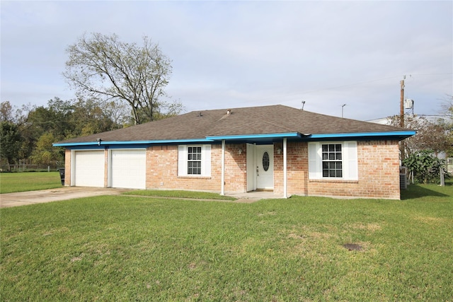 ranch-style house featuring a garage and a front lawn