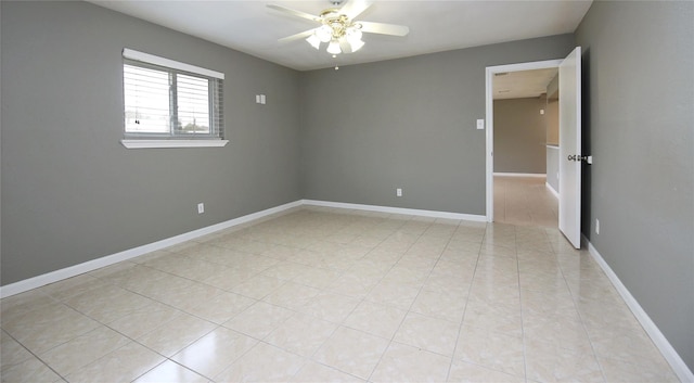 tiled spare room featuring ceiling fan