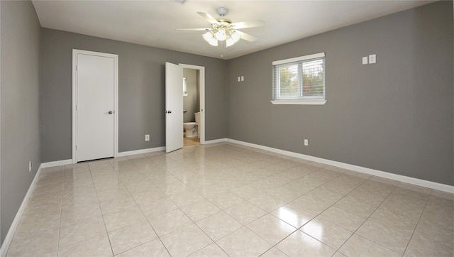 empty room featuring light tile patterned floors and ceiling fan