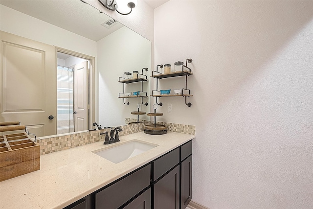 bathroom with vanity and backsplash