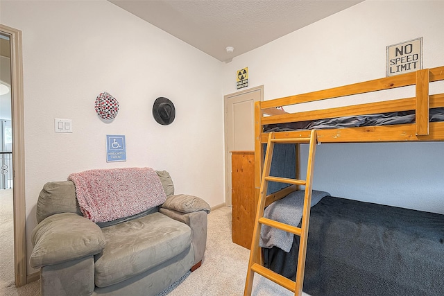 carpeted bedroom featuring lofted ceiling