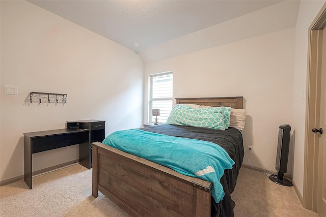 bedroom featuring lofted ceiling and light colored carpet