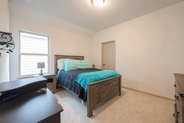 bedroom with light colored carpet, vaulted ceiling, and multiple windows