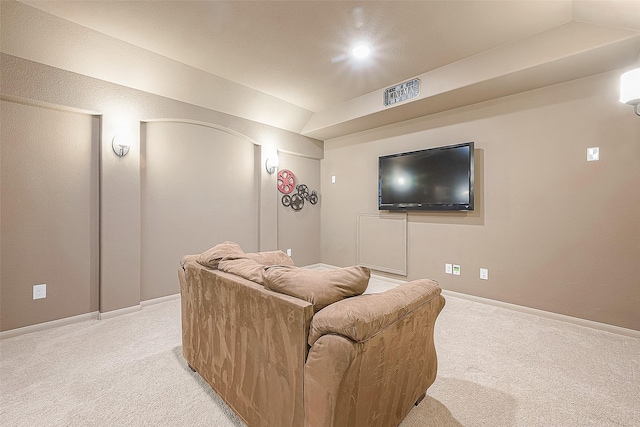 carpeted cinema room featuring lofted ceiling