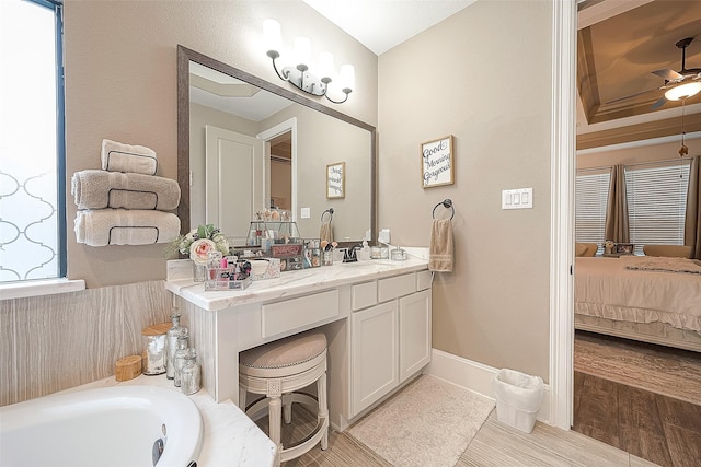 bathroom with ceiling fan, vanity, and a bathing tub