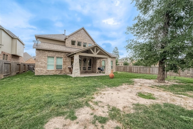 rear view of property with a lawn and a patio