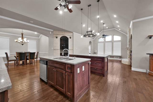 kitchen with ceiling fan with notable chandelier, decorative light fixtures, sink, stainless steel dishwasher, and a center island with sink