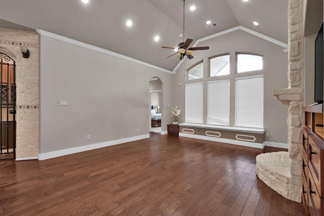 unfurnished living room with dark hardwood / wood-style flooring, a stone fireplace, vaulted ceiling, and ornamental molding