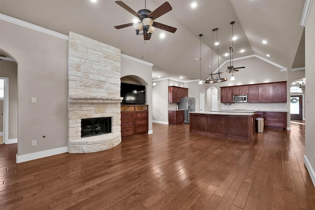 unfurnished living room featuring dark hardwood / wood-style flooring, a stone fireplace, high vaulted ceiling, and ceiling fan