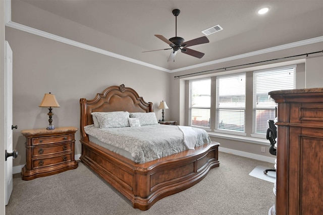 carpeted bedroom with ornamental molding and ceiling fan