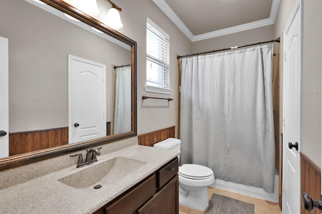 bathroom featuring wooden walls, ornamental molding, vanity, toilet, and tile patterned floors