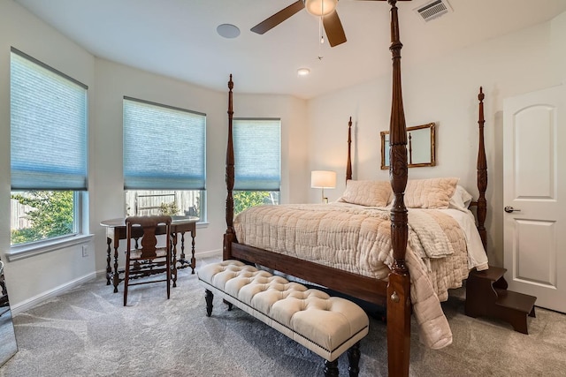 carpeted bedroom featuring baseboards, visible vents, and a ceiling fan