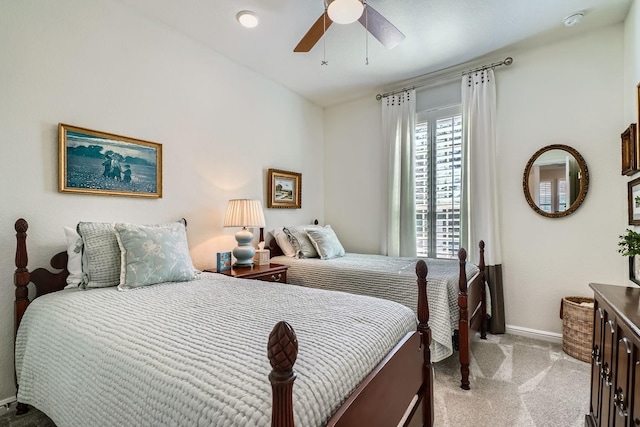 bedroom featuring light carpet, ceiling fan, and baseboards