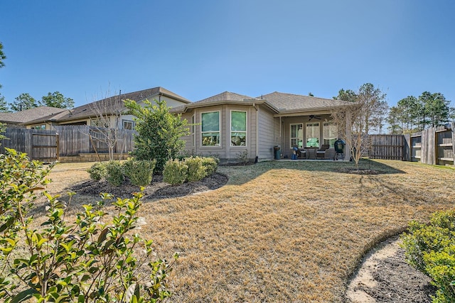 back of property featuring ceiling fan, a yard, a patio, and a fenced backyard