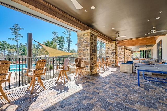 view of patio featuring an outdoor pool, an outdoor living space, and a ceiling fan