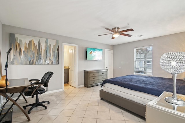 bedroom featuring light tile patterned flooring, ceiling fan, and ensuite bath