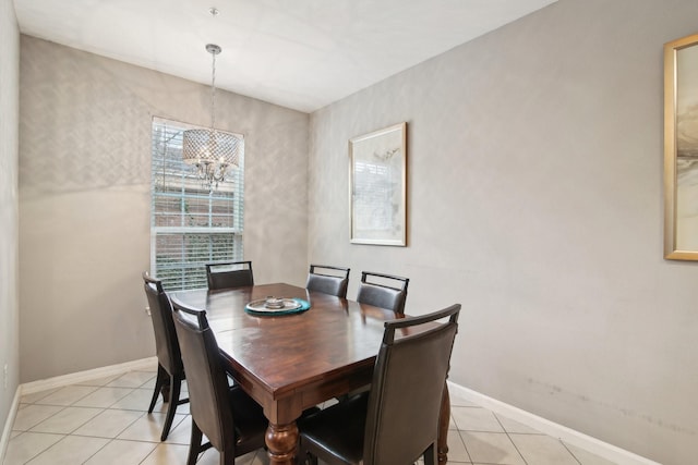 tiled dining space featuring an inviting chandelier