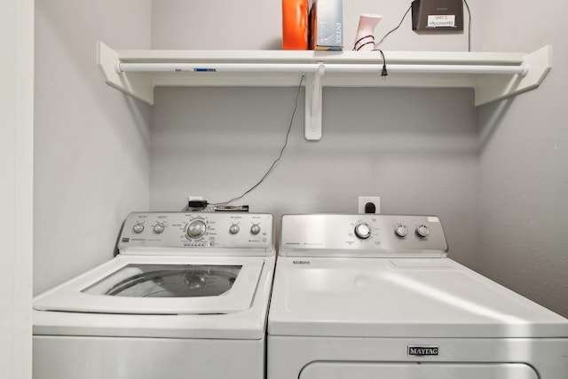 clothes washing area featuring washer and dryer