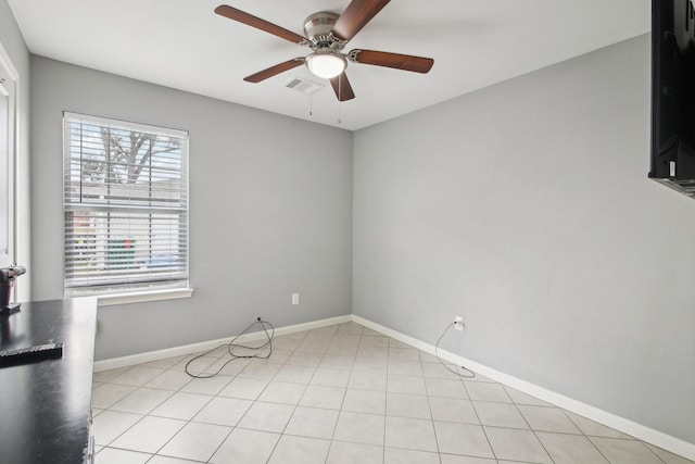 unfurnished room featuring ceiling fan and plenty of natural light