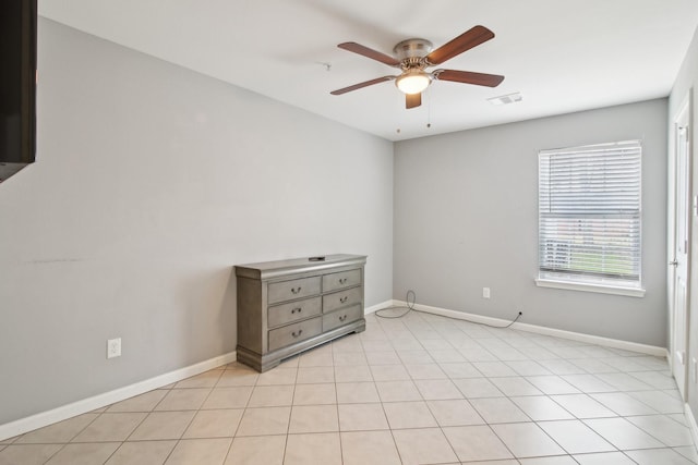 spare room with light tile patterned flooring and ceiling fan