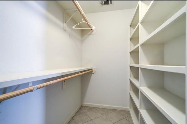 spacious closet featuring light tile patterned flooring