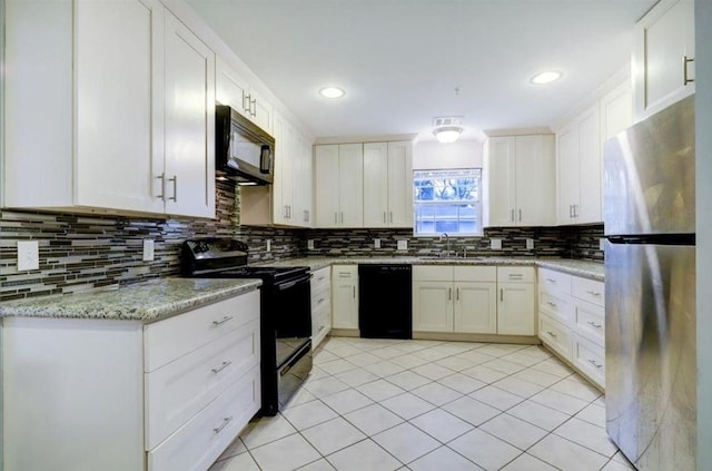 kitchen featuring white cabinetry, light stone countertops, and black appliances