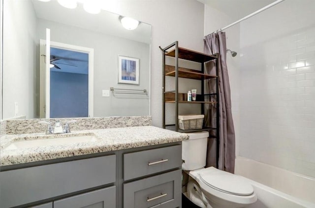 full bathroom featuring ceiling fan, vanity, toilet, and shower / bath combo