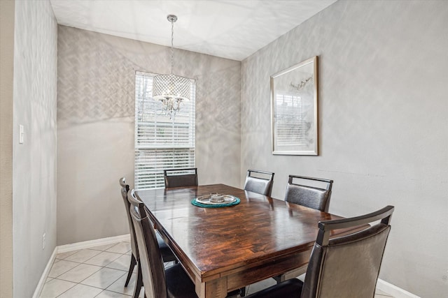 dining space featuring light tile patterned floors and a notable chandelier