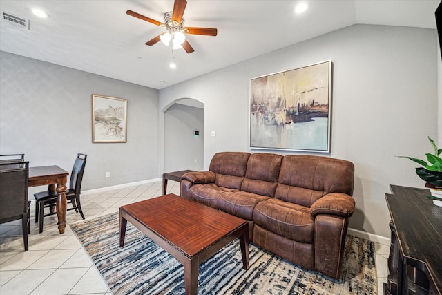 living room with vaulted ceiling, light tile patterned floors, and ceiling fan