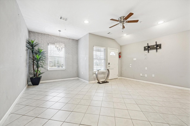 unfurnished room with ceiling fan with notable chandelier