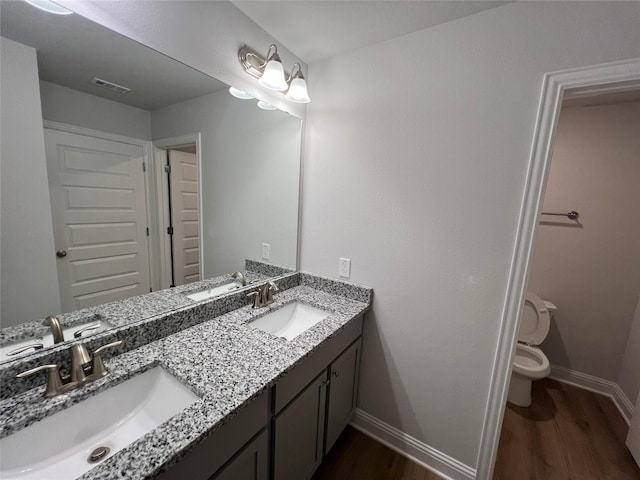 bathroom with vanity, hardwood / wood-style floors, and toilet