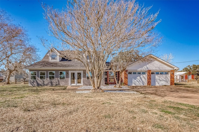 new england style home with a garage and a front lawn