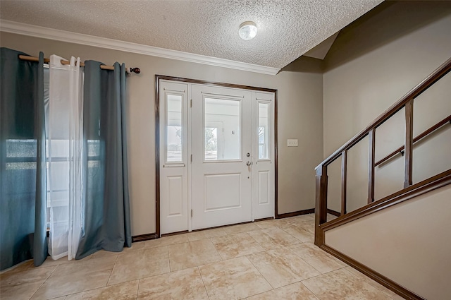 foyer with crown molding, light tile patterned floors, and a textured ceiling