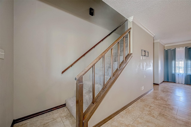 staircase featuring crown molding and a textured ceiling